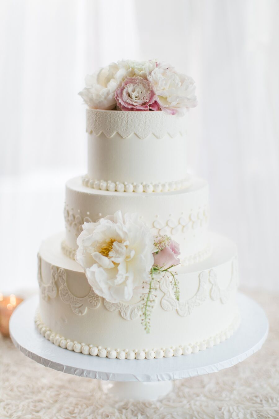 Wedding Cake With Floral and Fabric Details