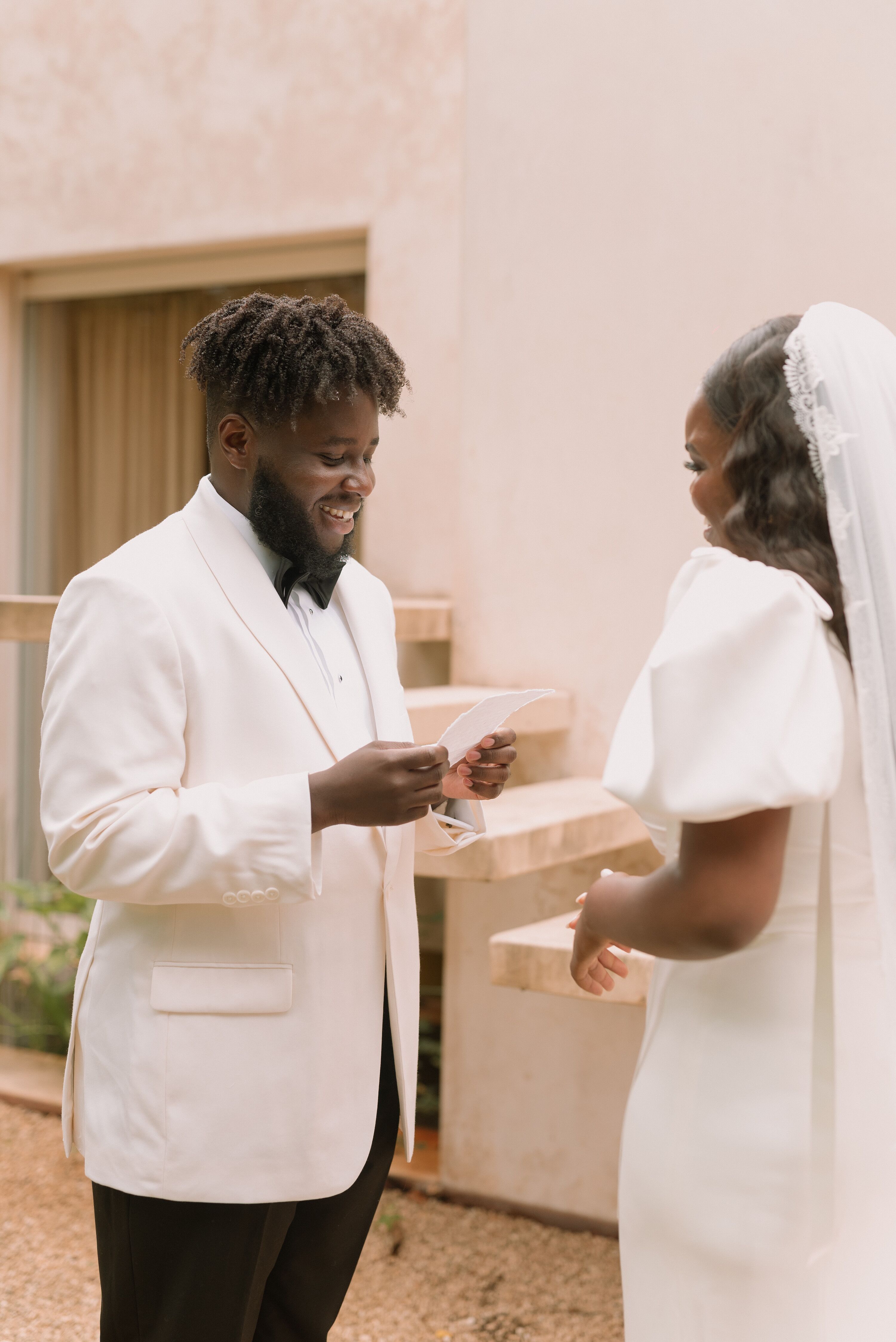 Groom in White-and-Black Tuxedo Reading Private Vows to Bride
