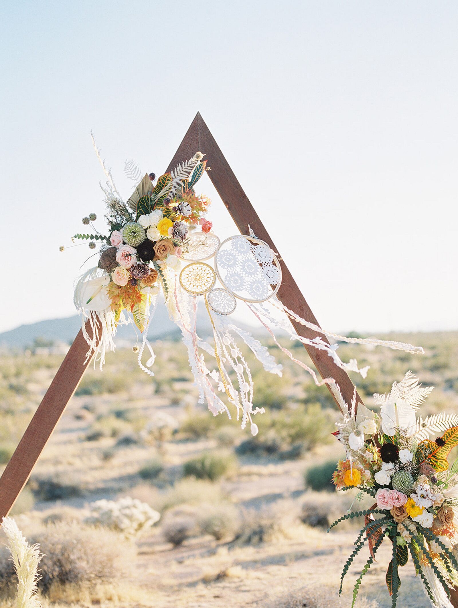 Triangular Wedding Arch Set the Stage for Boho Desert Wedding Ceremony