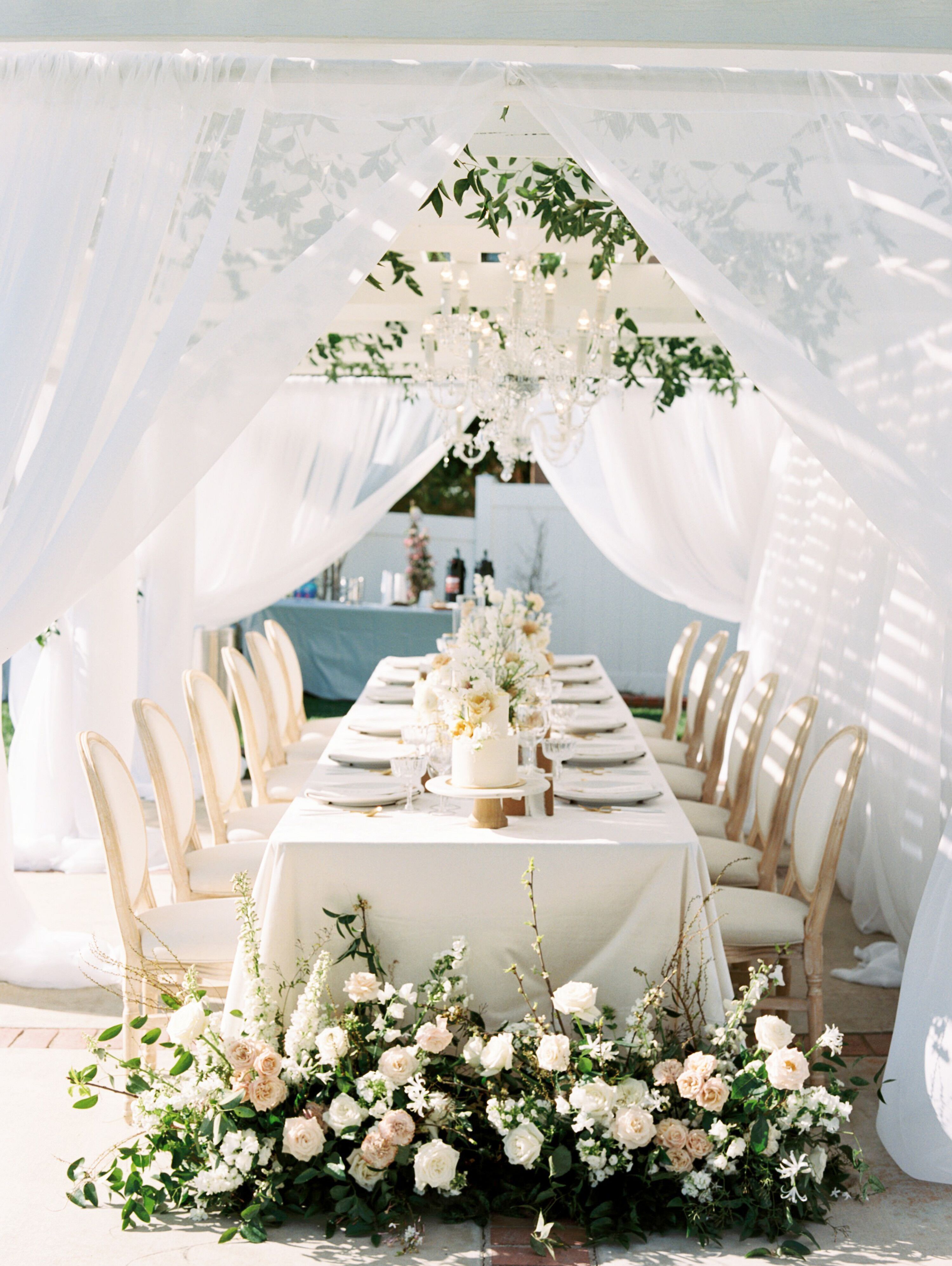 Wedding Reception With White Draping and Hanging Greenery