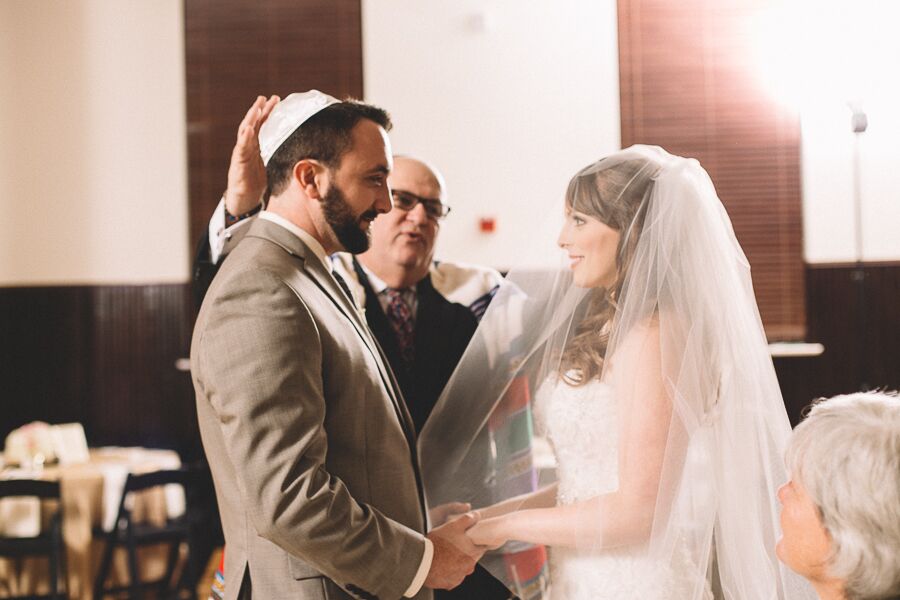 Jewish rabbi giving a blessing over the couple during the ceremony