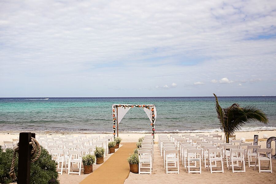 Casual Beach Ceremony With White Folding Chairs