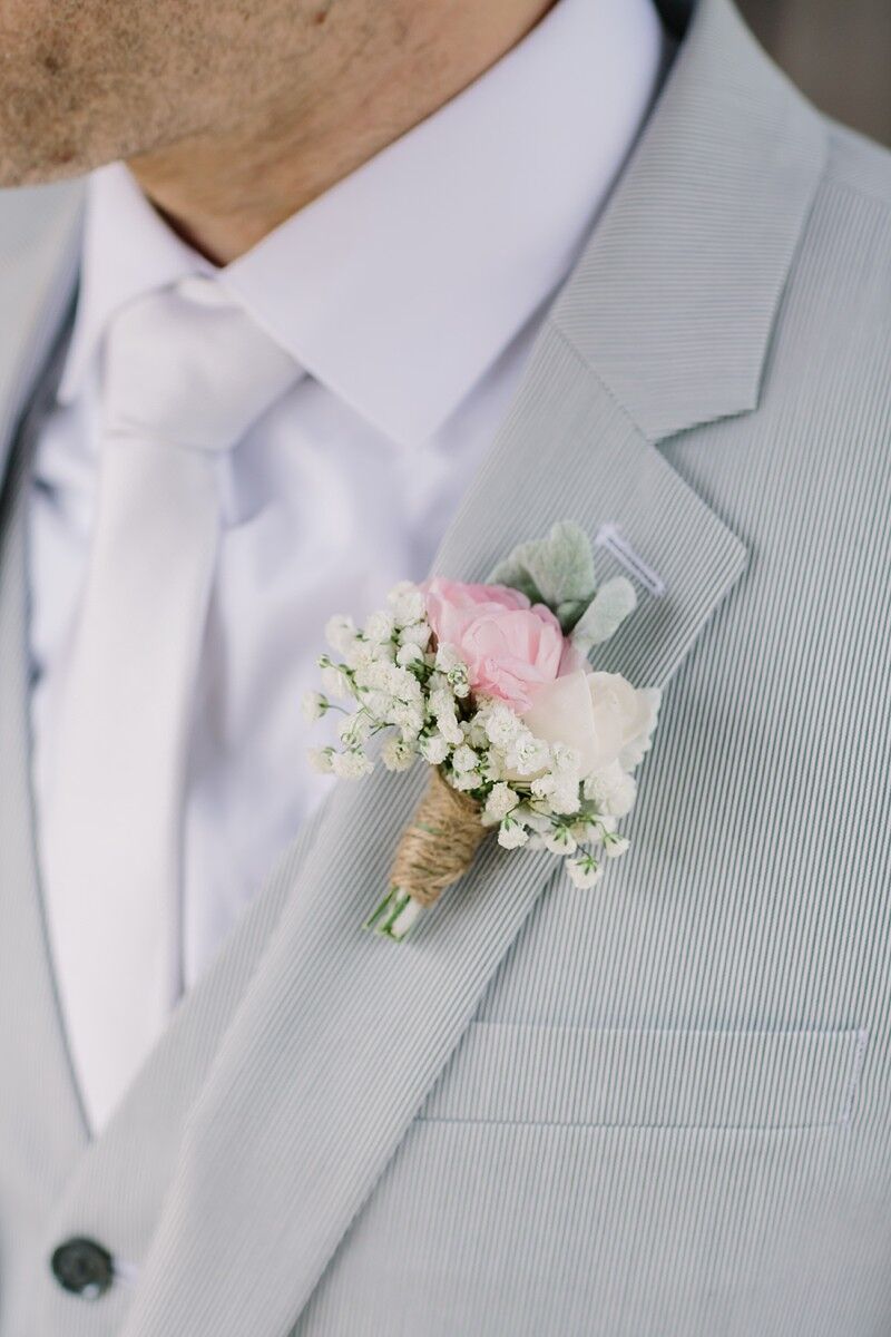 Blush Rose and Baby's Breath Boutonniere on Gray Groom's Suit