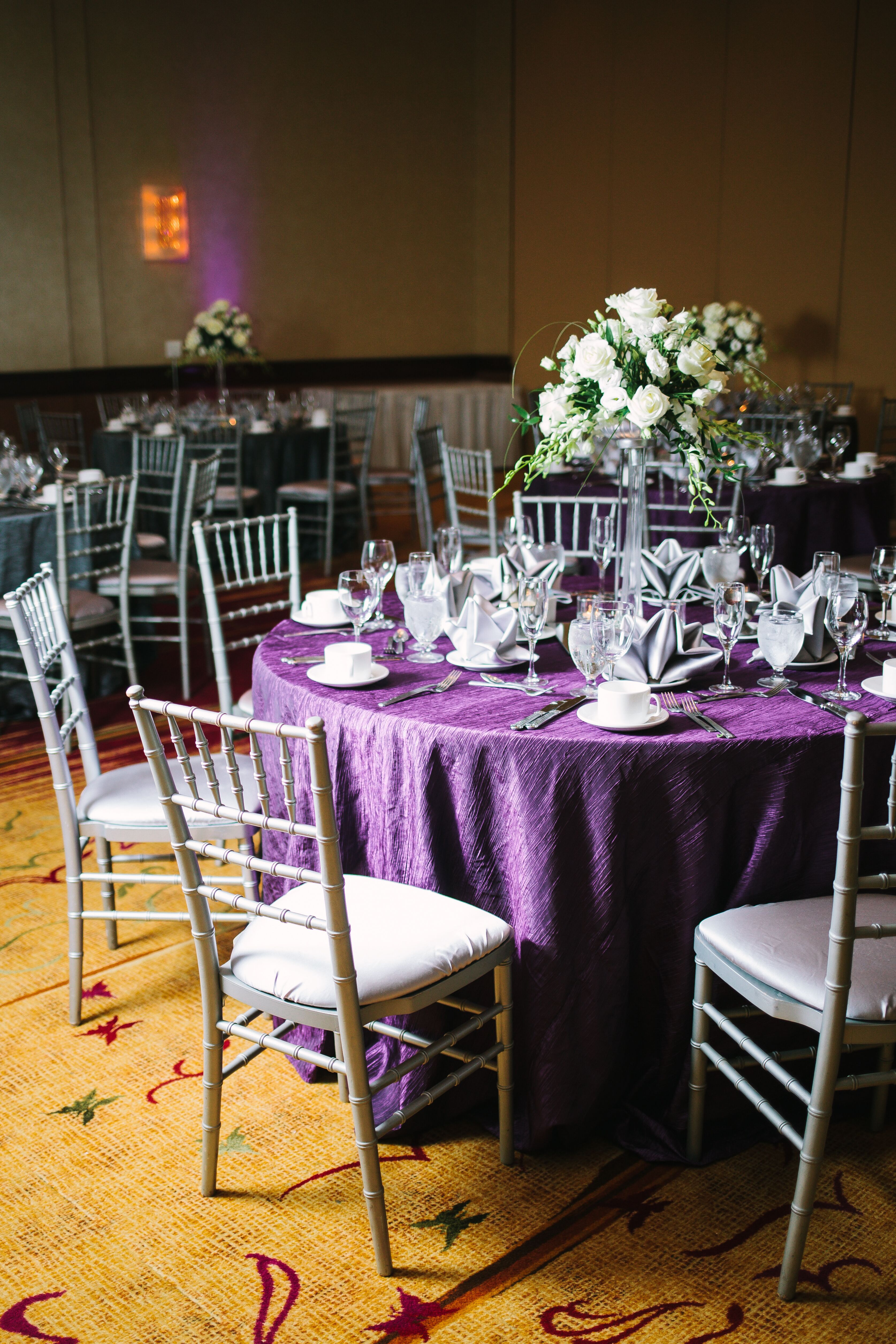 Purple Reception Tables With Silver Chiavari Chairs