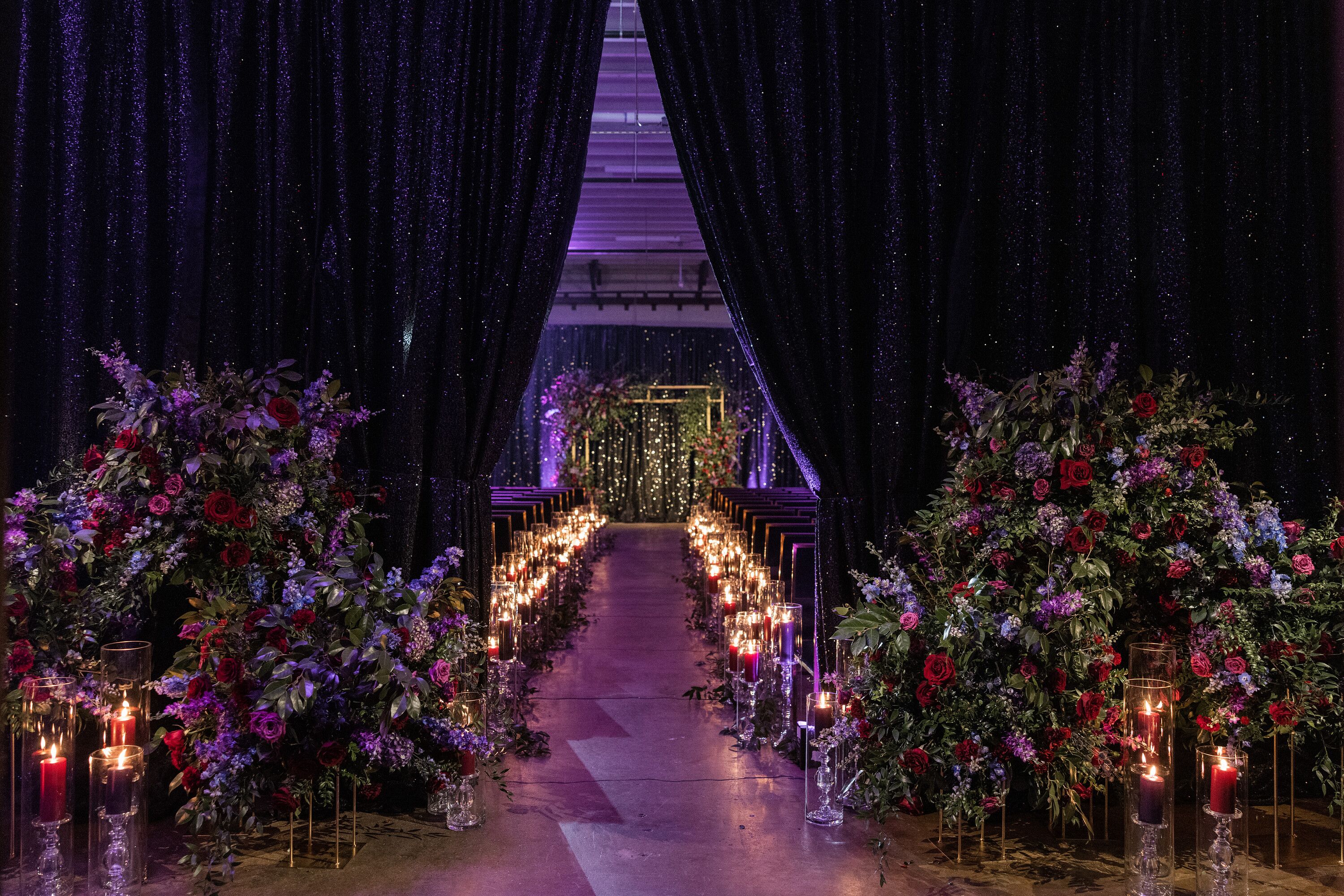 Moody Wedding Ceremony With Candles, Draping and Purple Lighting