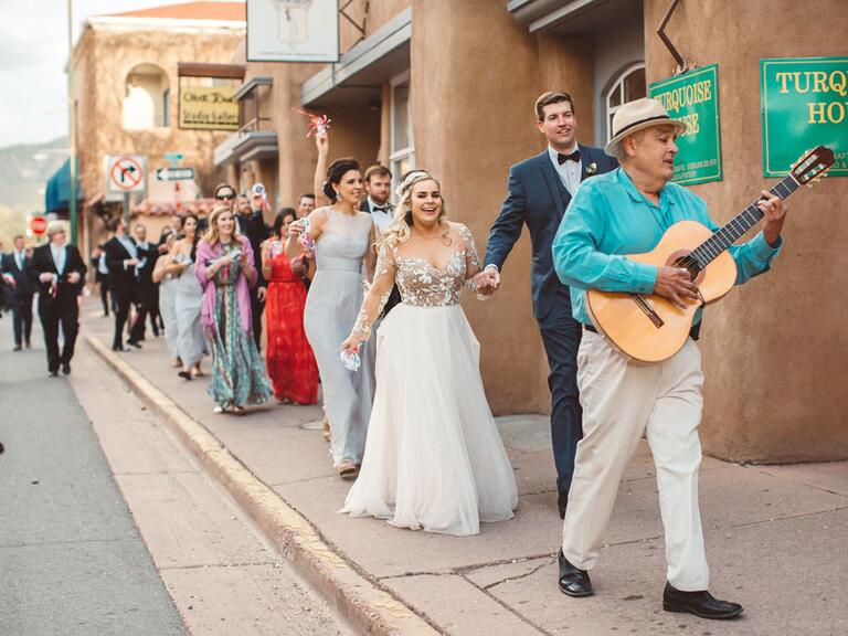 Wedding party walking through Santa Fe. 