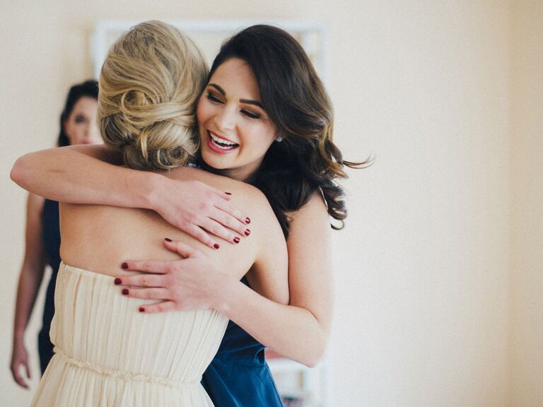 bride and bridesmaid hugging