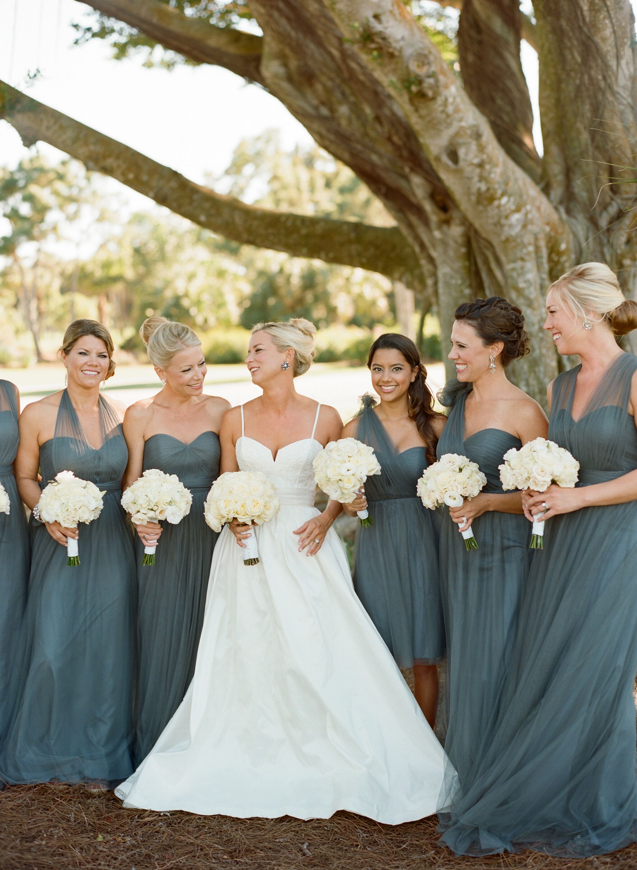 Tulle Accented Bridesmaids Dresses with White Bouquets