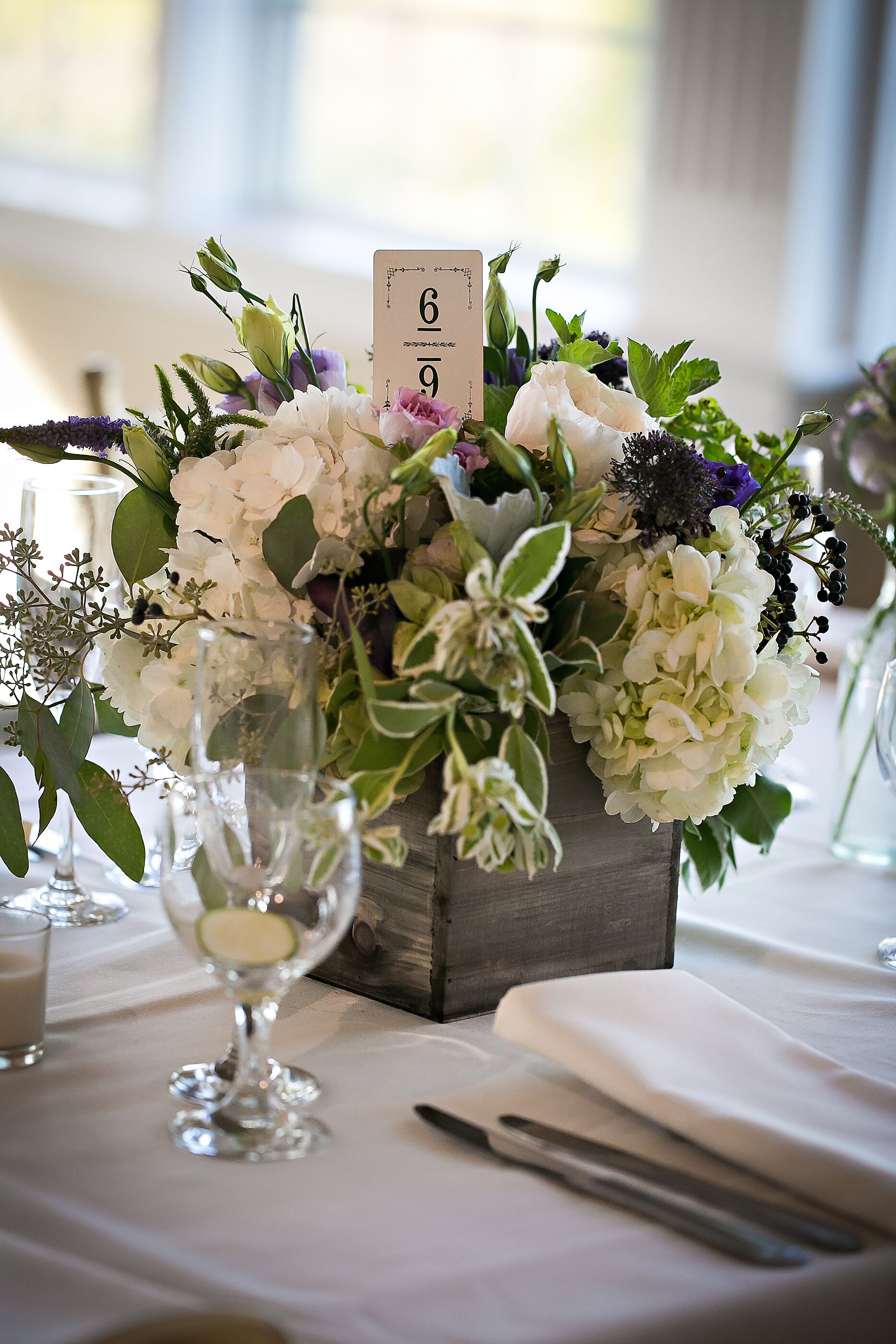 Ivory Hydrangea Centerpieces in Distressed Wooden Vases