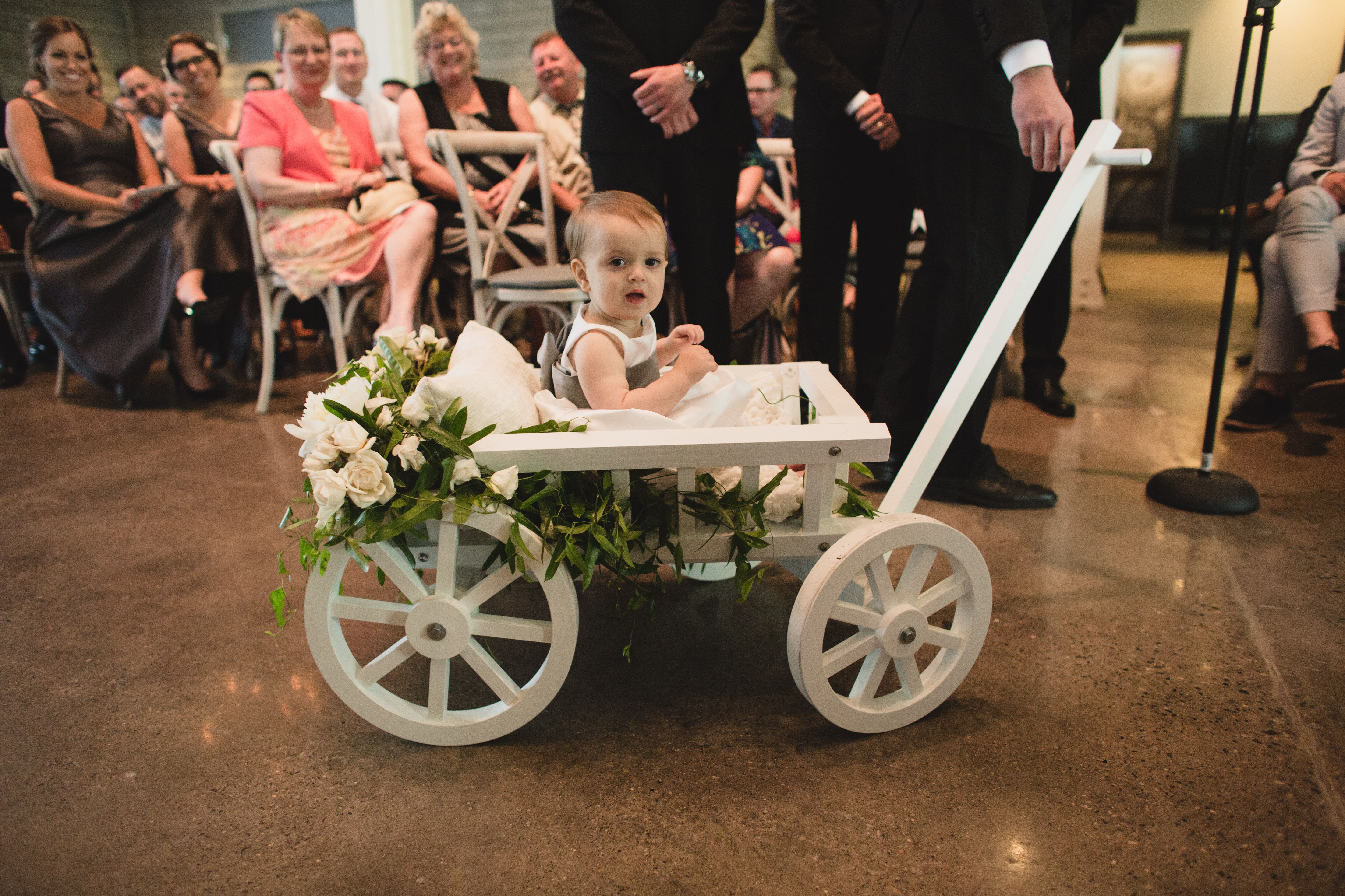 Flower Girl in White Wooden Wagon