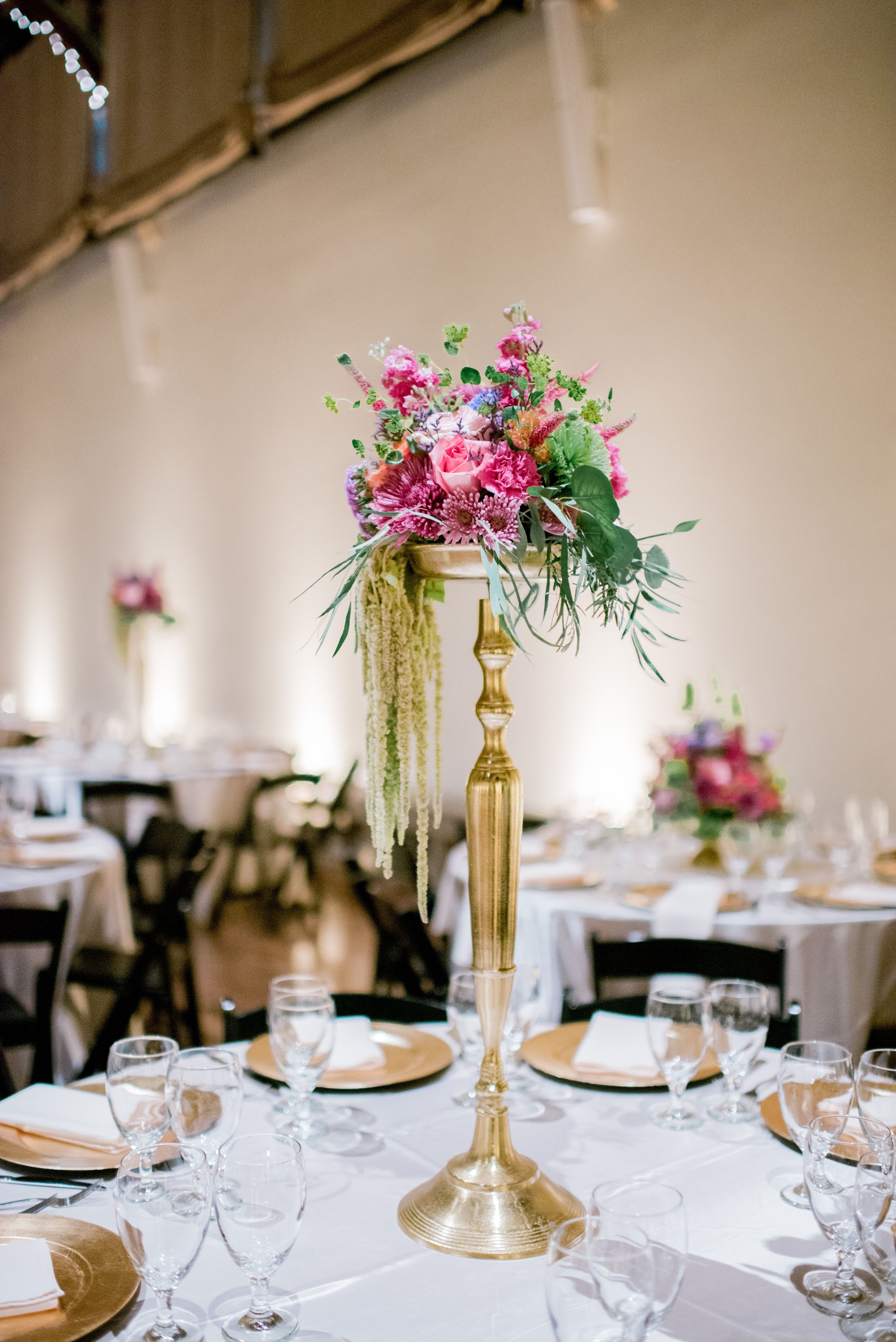 Colorful Flower Arrangements on Tall Gold Stands