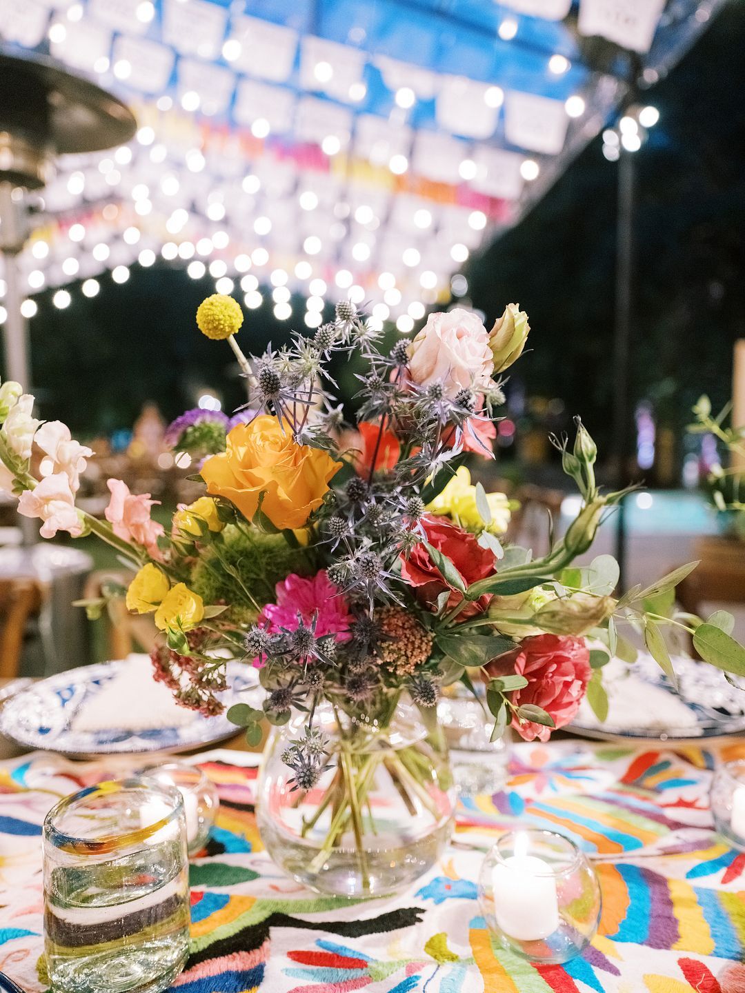 Low, Boldly Colorful Centerpieces in Clear Vase on Vibrant Table Linen ...