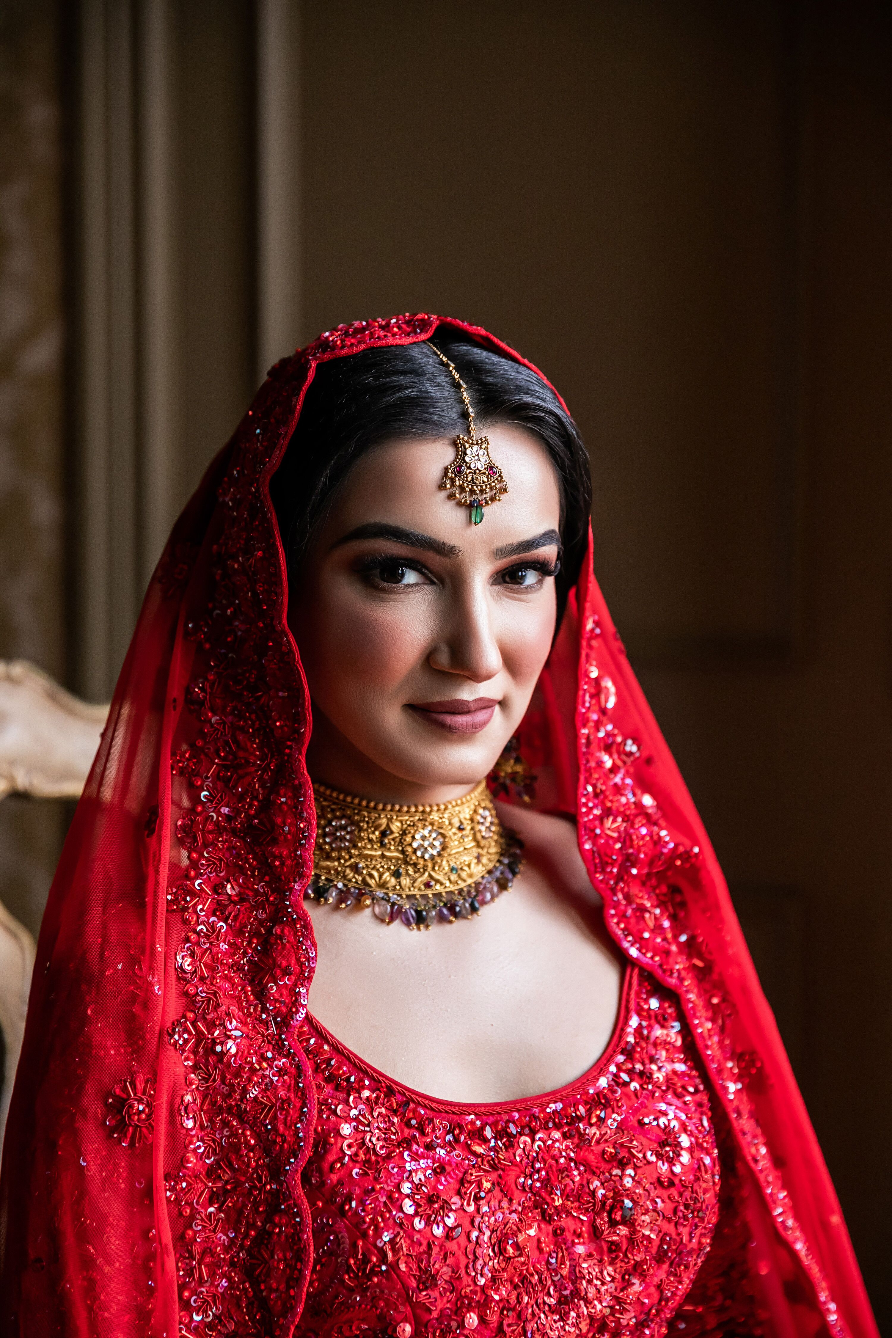 Bride Wearing Red Indian Veil and Traditional Indian Bridal Jewelry