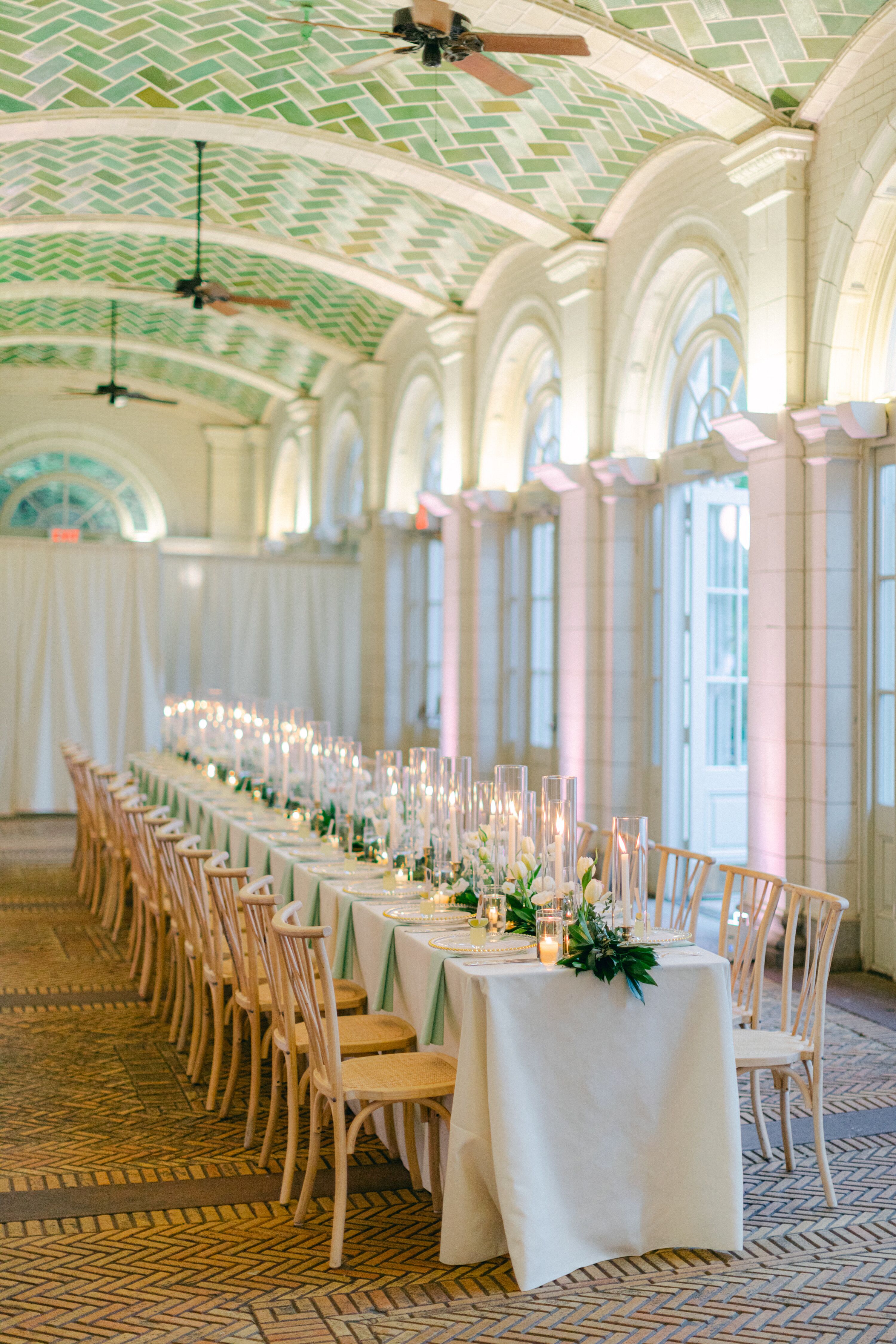 Long Reception Table in the Boathouse With White Linen, Simple Greenery ...