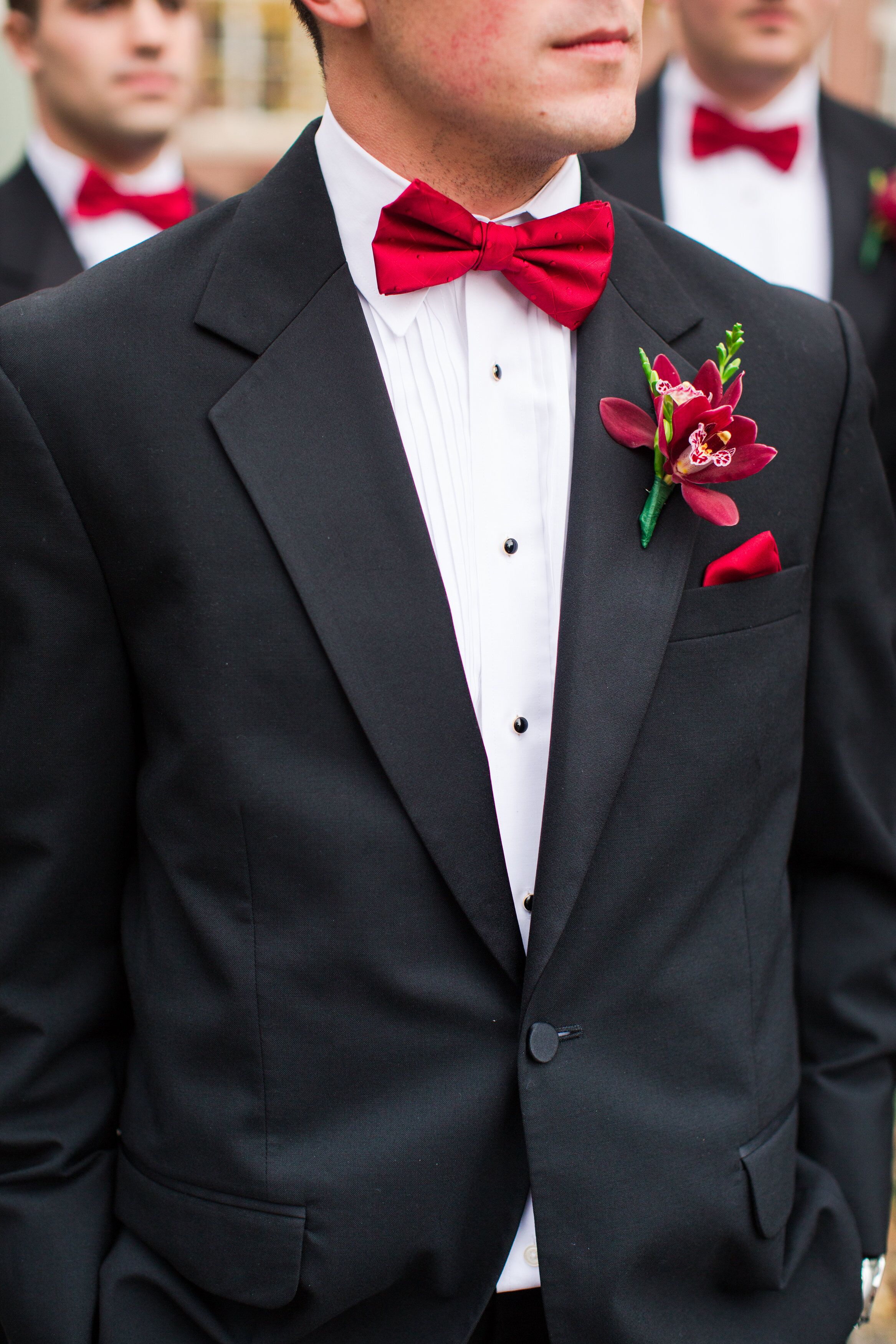 Groomsmen in Black Tuxedos with Red Bow Ties