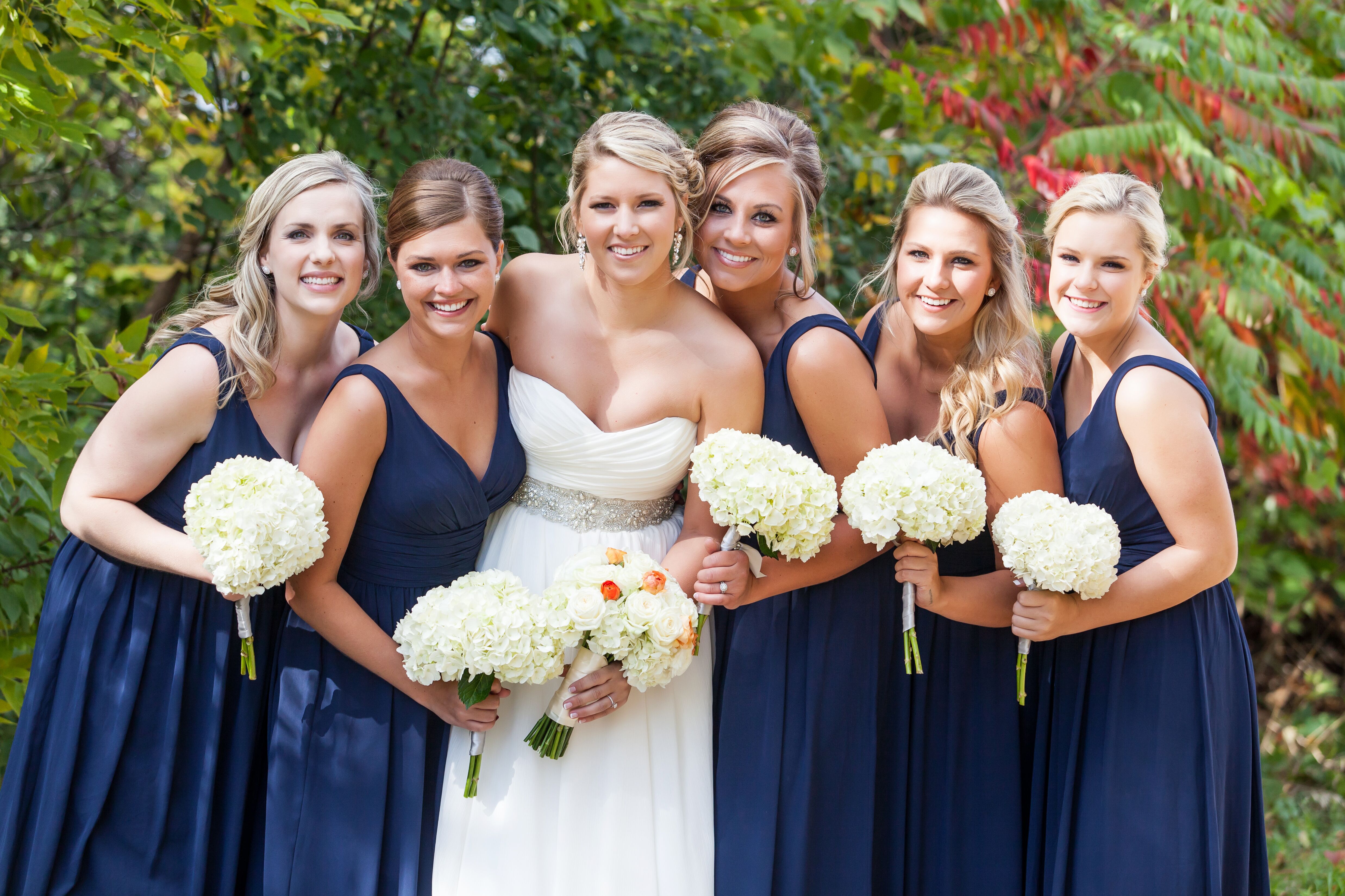 Long, Navy, V-Neck Bridesmaid Dresses with White Hydrangea Bouquets