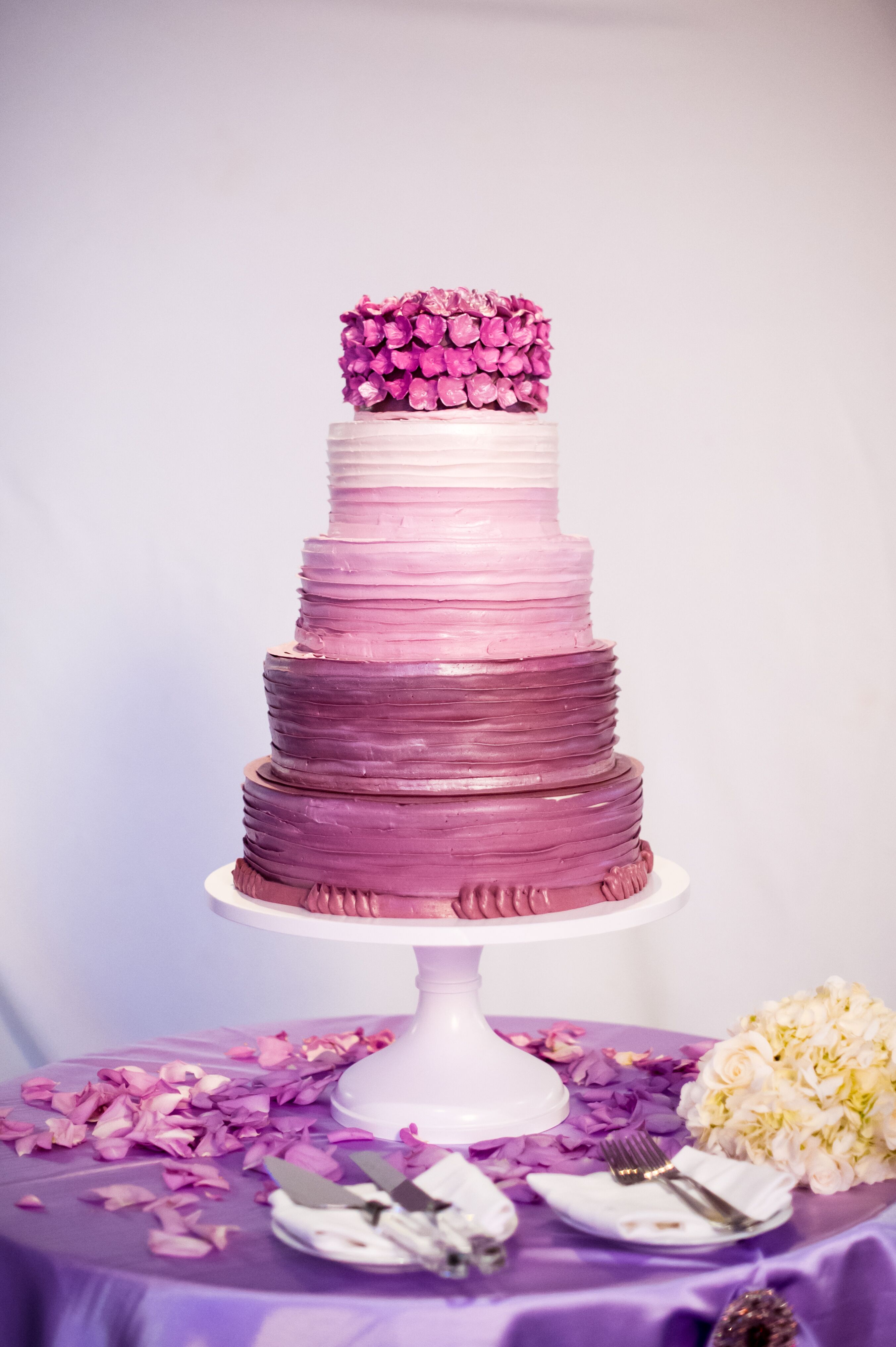 Check out this purple ombre cake with sugar flowers and see more inspiratio...