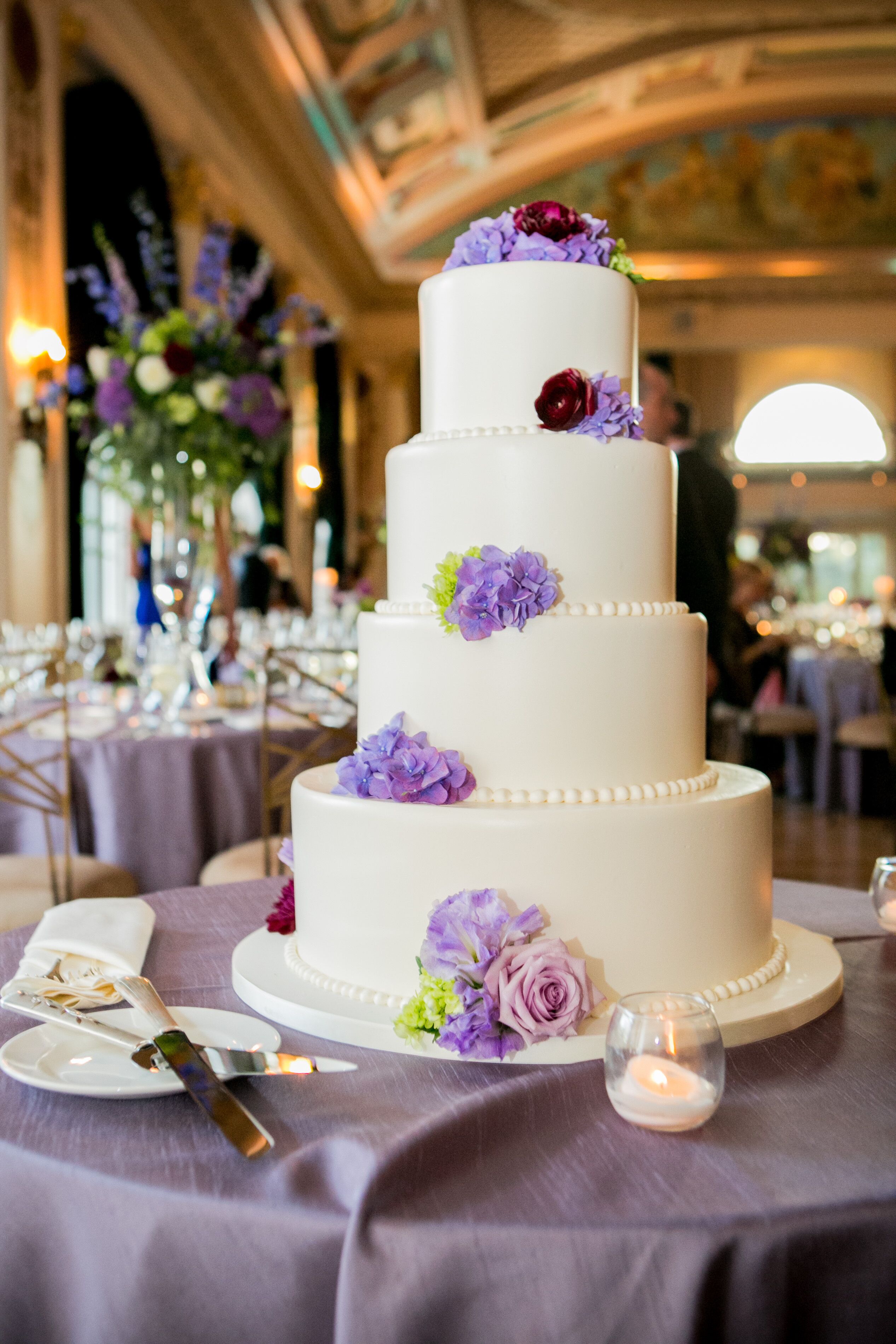 Four-Tier Wedding Cake With Purple Flowers