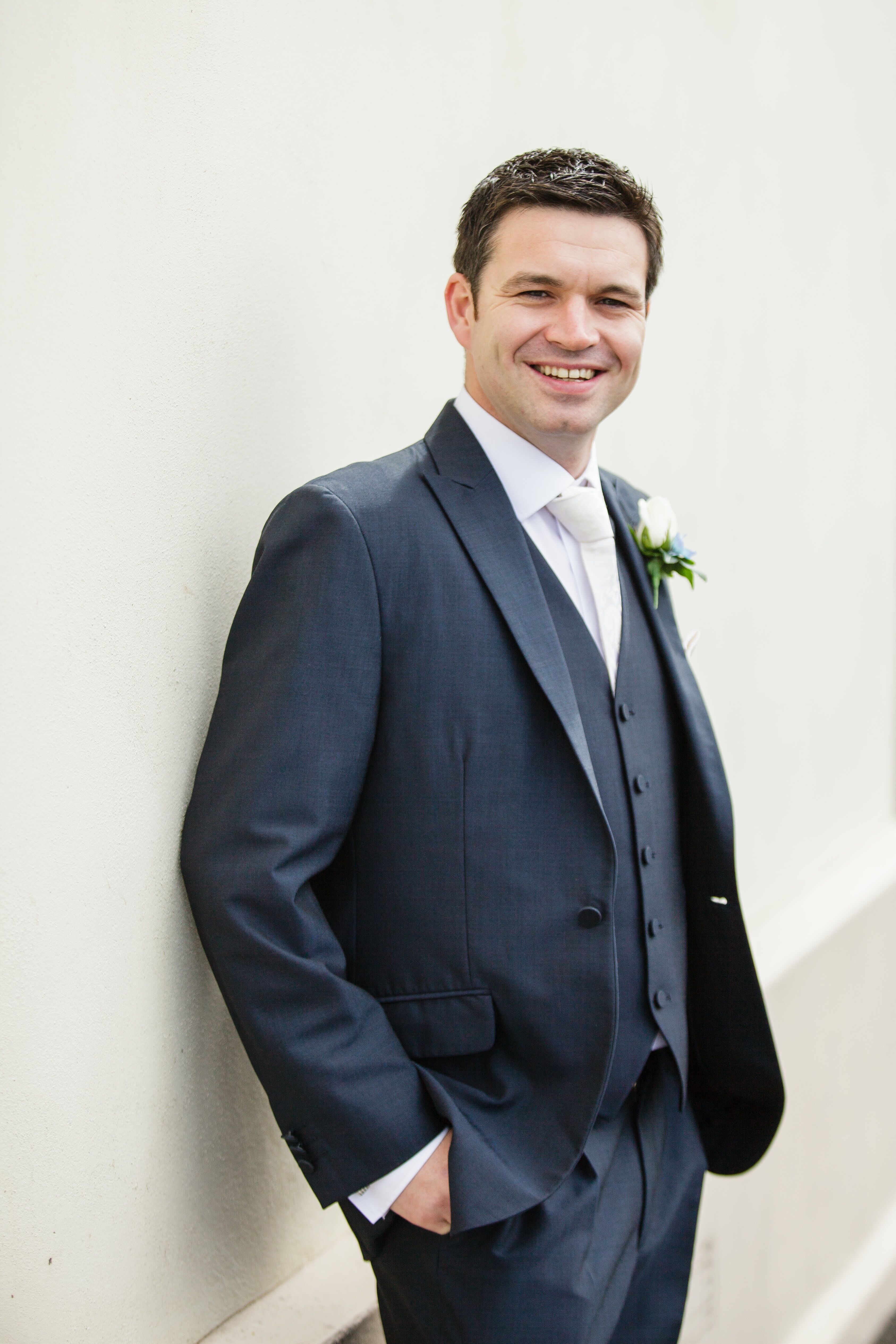 Groom in a Gray Three Piece Suit and White Tie