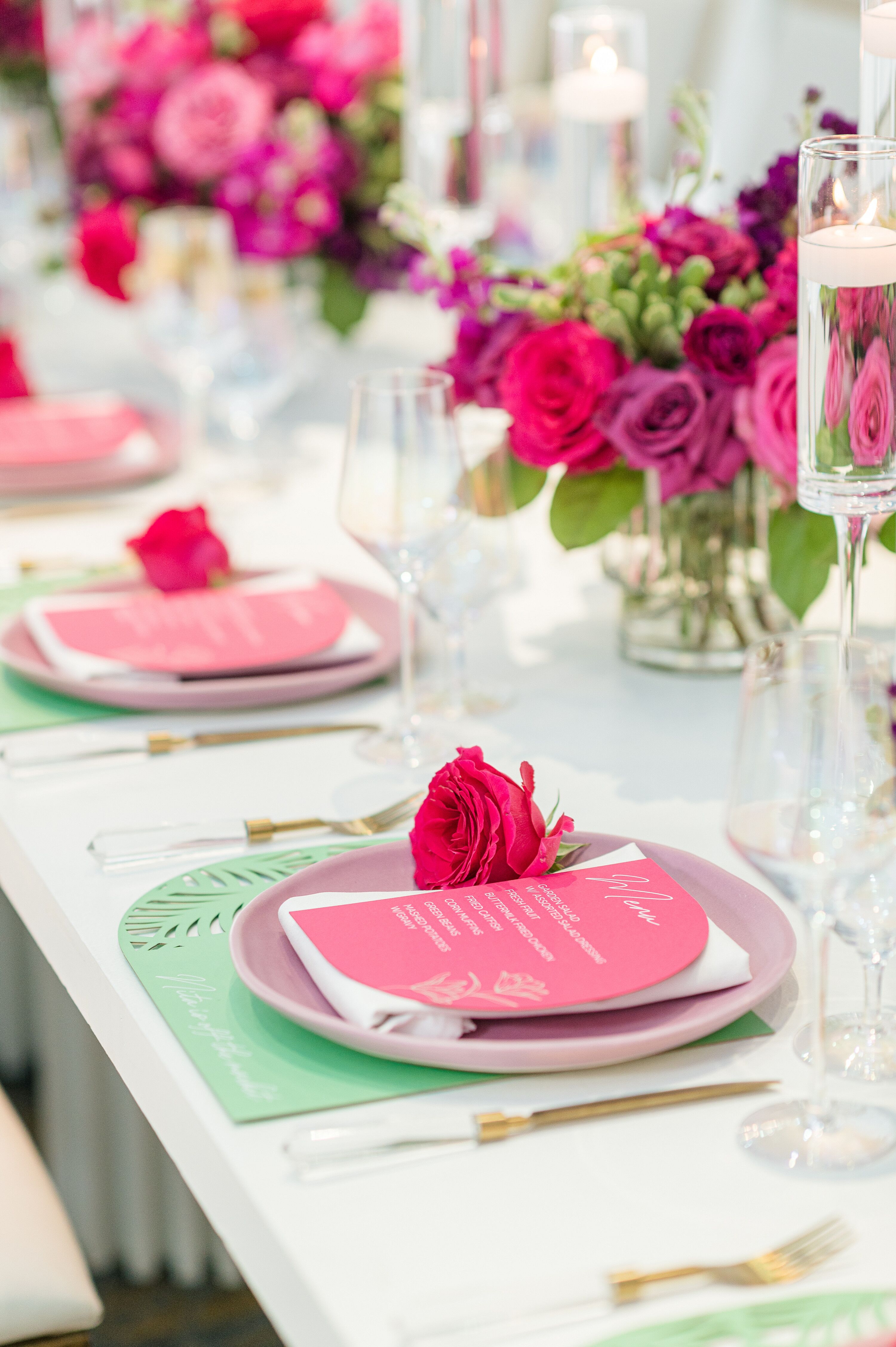 A Table With Pink Flowers And Menus On It