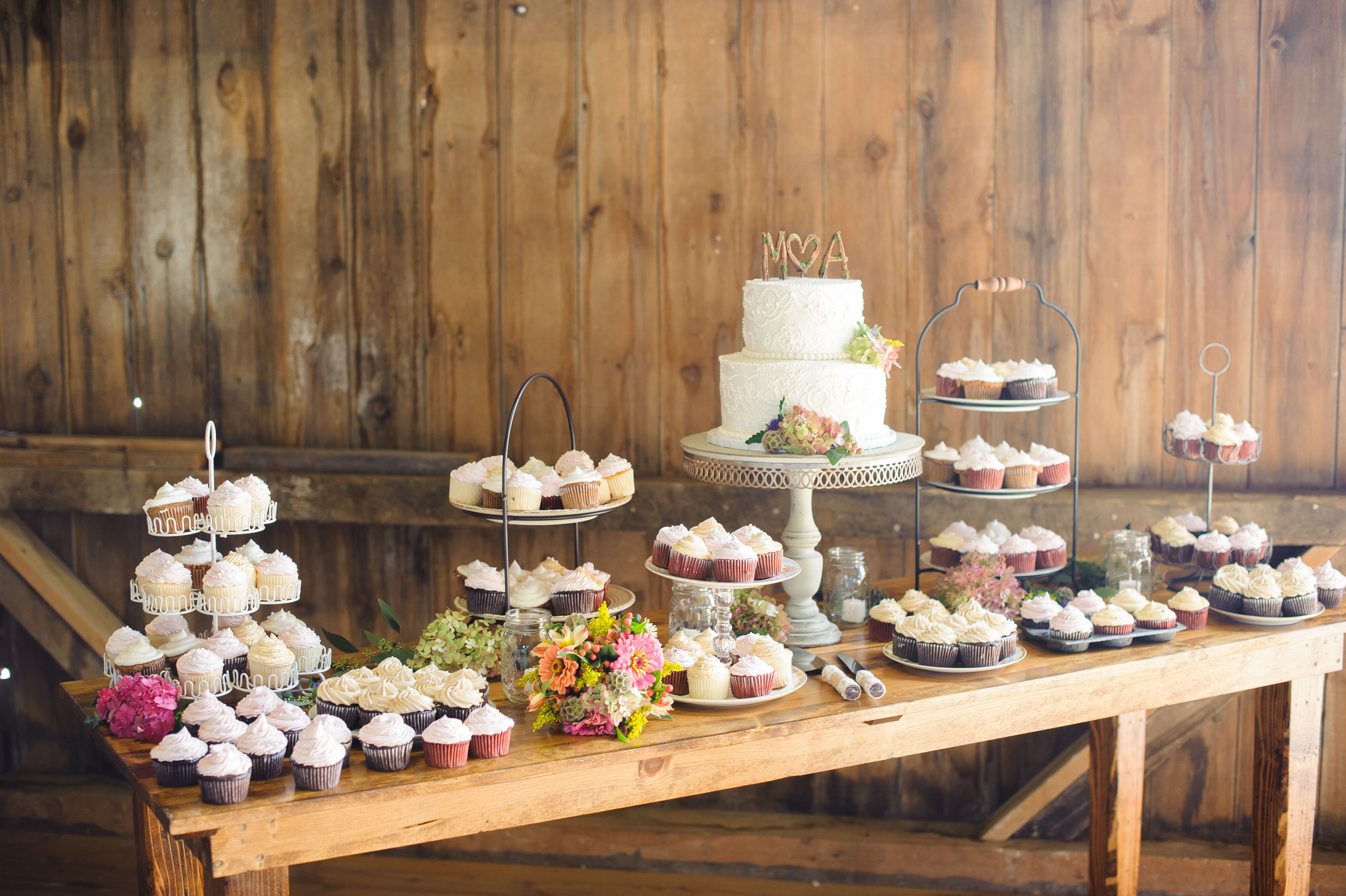 Dessert Table with an Assortment of Cupcakes at Barn Wedding