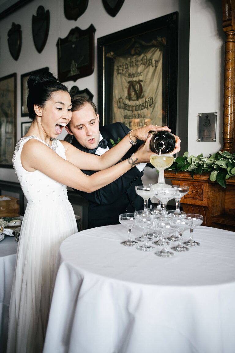 Bride and groom pouring champagne tower