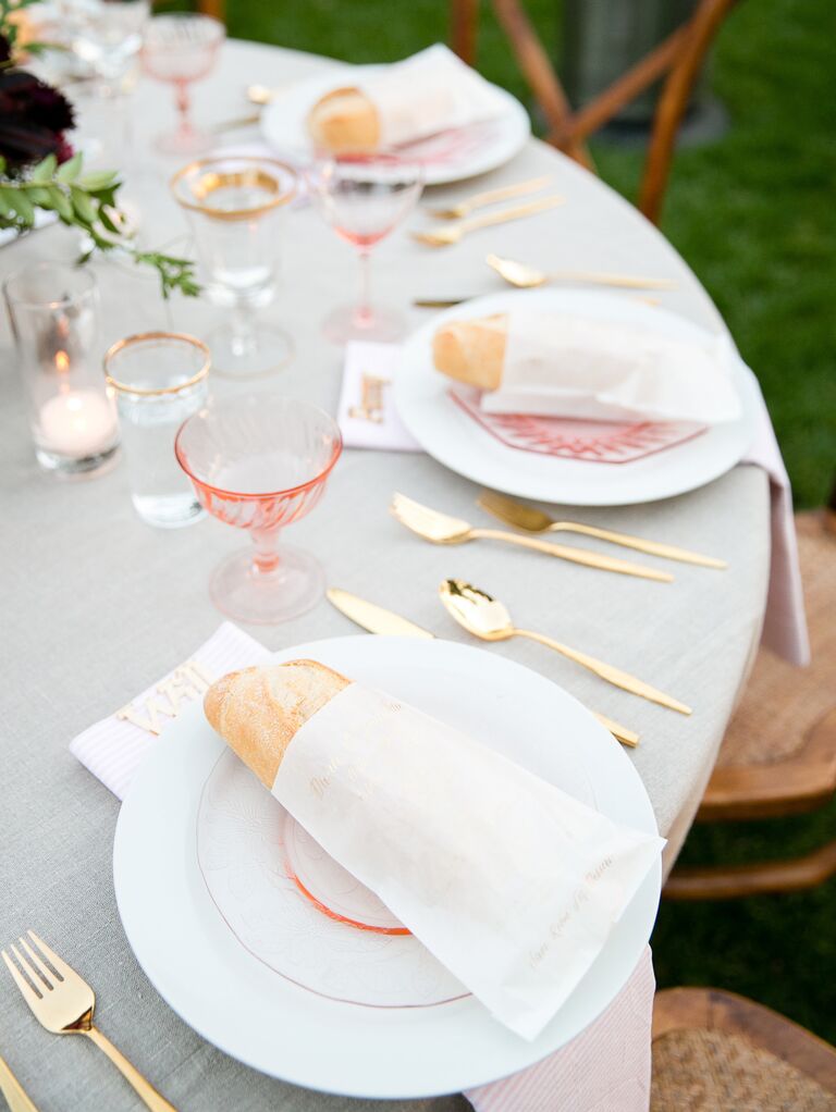Pink and gold place settings at outdoor wedding reception