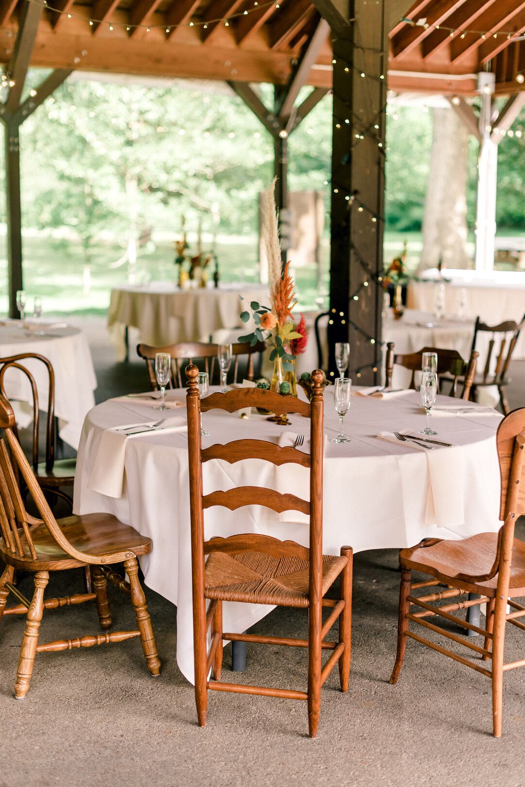 Eclectic Dining Table with Mismatched Chairs and Ivory Linen